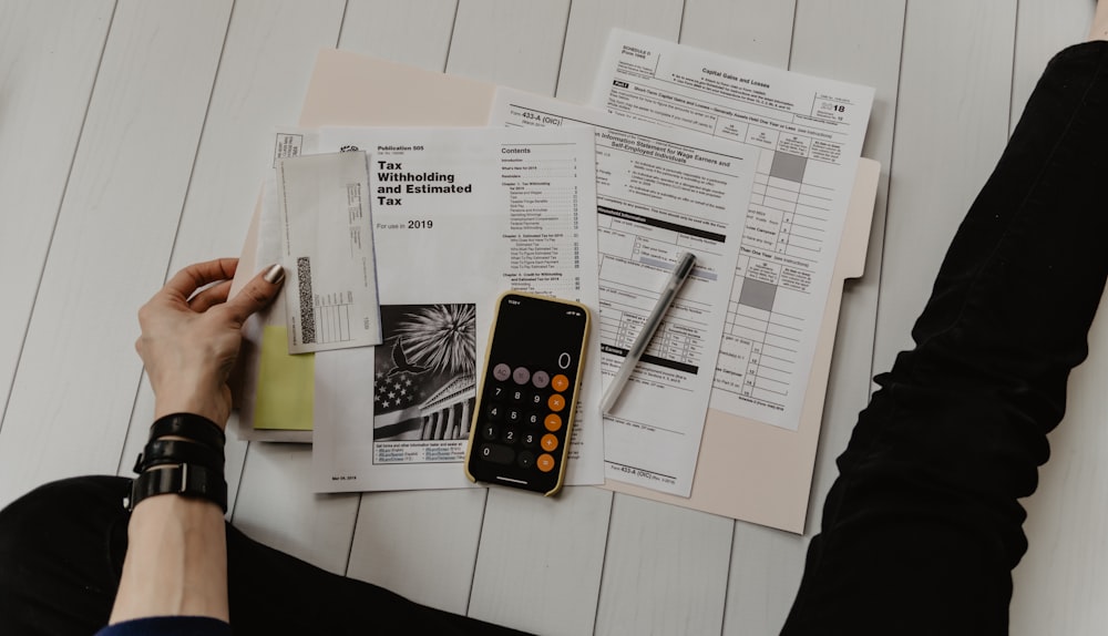 Calculator and tax documents on a desk representing UK tax planning and calculations